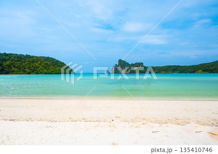 Landscape view of coastline with limestone rock and boats on ocean at Ko Phi Phi islands, Thailand. Concept of exotic tropical vacation and beautiful nature in paradise 135410746
