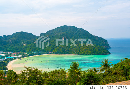 Aerial view of Ko Phi Phi islands, Thailand. Lookout from the viewpoint to tropical island, beach and ocean with long tail boats. Exotic nature, summer weather. 135410758