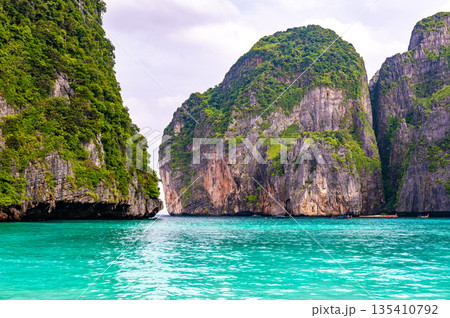 View of famous Maya Bay, Thailand. One of the most popular beach in the world. Ko Phi Phi islands. Beach without people. View of famous Maya Bay, Thailand. One of the most popular beach in the world. Ko Phi Phi islands. Beach without people. 135410792