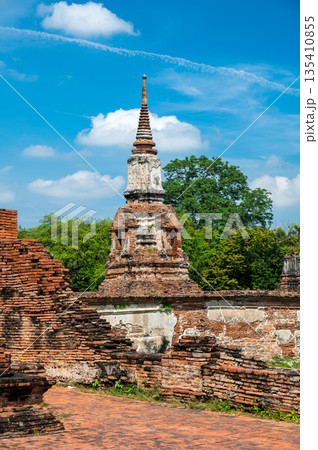 Ruins of ancient city and temples Ayutthaya, Thailand. Old kingdom of Siam. Summer day with blue sky. Famous tourist destination, spiritual place near Bangkok. Ruins of ancient city and temples Ayutthaya, Thailand. Old kingdom of Siam. Summer day with blue sky. Famous tourist destination, spiritual place near Bangkok. 135410855
