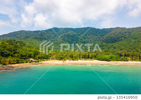 Aerial drone view of tropical beach at Ko Lanta island, Thailand. Coastline view of famous target destination. Pure turquoise water and white sand. Aerial drone view of tropical beach at Ko Lanta island, Thailand. Coastline view of famous target destination. Pure turquoise water and white sand. 135410950