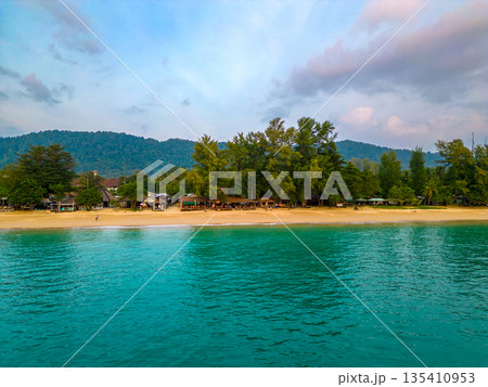 Aerial drone view of tropical beach at Ko Lanta island, Thailand. Coastline view of famous target destination. Pure turquoise water and white sand. Aerial drone view of tropical beach at Ko Lanta island, Thailand. Coastline view of famous target destination. Pure turquoise water and white sand. 135410953