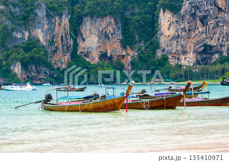 Long tail boats at Railay beach, Krabi, Thailand. Tropical paradise, turquoise water and white sand. 135410971