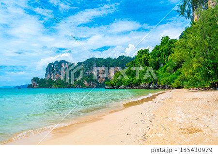 Long tail boats at Railay beach, Krabi, Thailand. Tropical paradise, turquoise water and white sand. Long tail boats at Railay beach, Krabi, Thailand. Tropical paradise, turquoise water and white sand. 135410979