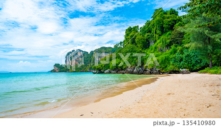 Long tail boats at Railay beach, Krabi, Thailand. Tropical paradise, turquoise water and white sand. Long tail boats at Railay beach, Krabi, Thailand. Tropical paradise, turquoise water and white sand. 135410980