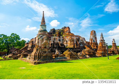 Ruins of ancient city and temples Ayutthaya, Thailand. Old kingdom of Siam. Summer day with blue sky. Famous tourist destination, spiritual place near Bangkok. 135411011