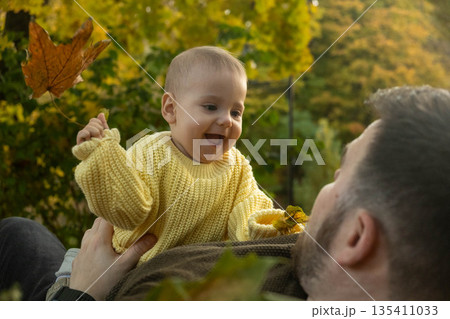 Father and Baby Enjoying Autumn Leaves 135411033
