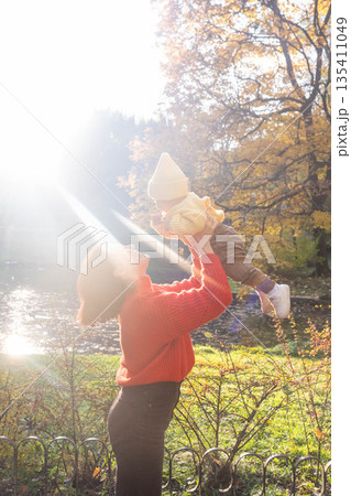 Father and Baby Enjoying Autumn in the Park Father and Baby Enjoying Autumn in the Park 135411049