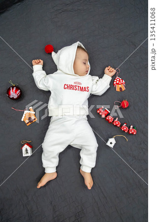 Sleeping Baby in Christmas Outfit 135411068