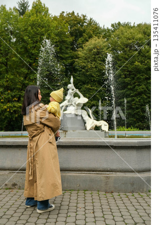 Mother and Child by Park Fountain 135411076