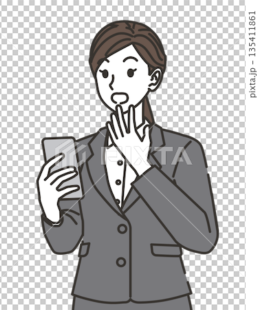 A woman in a suit surprised at her smartphone 135411861