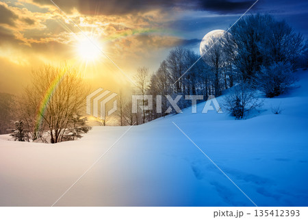 gorgeous winter landscape in mountains. day and night time change concept. beautiful trees in hoarfrost on snow covered hill with sun and moon. glowing overcast sky. harmony and progress calendar gorgeous winter landscape in mountains. day and night time change concept. beautiful trees in hoarfrost on snow covered hill with sun and moon. glowing overcast sky. harmony and progress calendar 135412393