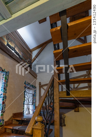 Unique rustic staircase with branch-style metal railings and mosaic Unique rustic staircase with branch-style metal railings and mosaic 135412490