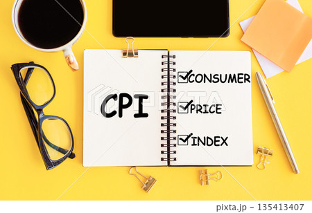 CPI - Consumer Price Index acronym, with text on notepad and office accessories on yellow desk. CPI - Consumer Price Index acronym, with text on notepad and office accessories on yellow desk. 135413407