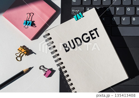 Notebook with tools and notes about BUDGET lies on laptop. Notebook with tools and notes about BUDGET lies on laptop. 135413408