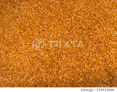 Lentil background texture, many dried red lentils. Healthy pulse food ingredient Lentil background texture, many dried red lentils. Healthy pulse food ingredient 135413606