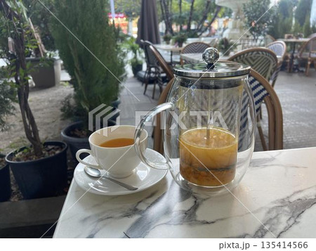 teapot and cups of tea on the table teapot and cups of tea on the table 135414566