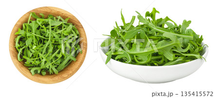 Heap of green fresh rucola or arugula leaf in wooden and ceramic bowl isolated on white background. Top view, flat lay Heap of green fresh rucola or arugula leaf in wooden and ceramic bowl isolated on white background. Top view, flat lay 135415572