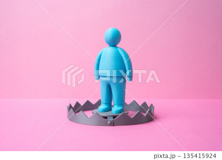 A male figurine as bait in a trap. A romantic relationship trap. Online dating fraud. Scam awareness concept, emotional manipulation, financial deception and digital trust risks 135415924