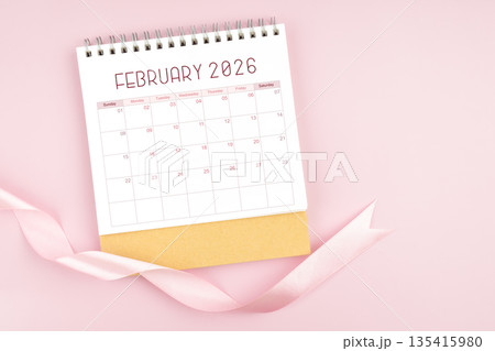 February 2026 desk calendar with pink pastel ribbon. 135415980
