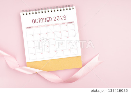 October 2026 desk calendar with pink pastel ribbon. 135416086