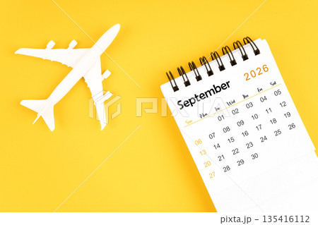 September 2026 calendar and airplane toy on yellow background. September 2026 calendar and airplane toy on yellow background. 135416112
