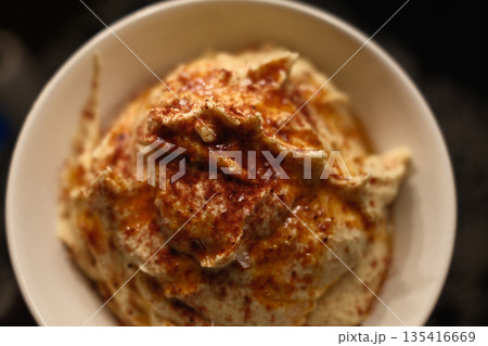 Traditional chickpea hummus with olive oil, spices, and fresh toppings. Traditional chickpea hummus with olive oil, spices, and fresh toppings. 135416669