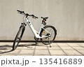 Bicycle isolated on a wall background, with copy space for text 135416889