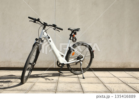 Bicycle isolated on a wall background, with copy space for text 135416889