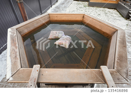 Intimate outdoor tub surrounded by warm timber accents and tranquil scenery Intimate outdoor tub surrounded by warm timber accents and tranquil scenery 135416898