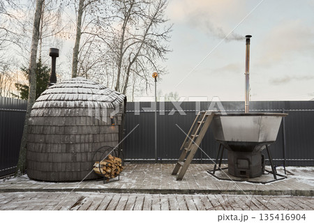 Charming wooden sauna nestled among birch trees with snow 135416904
