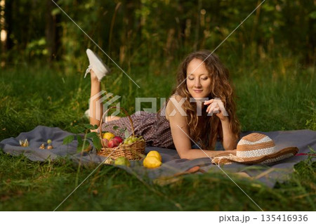 Woman in whimsical pose holding apples creatively Woman in whimsical pose holding apples creatively 135416936