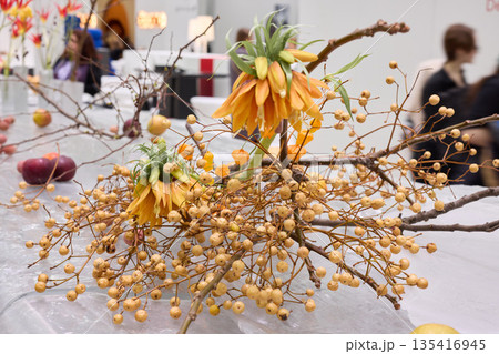 Chic floral centerpiece with vibrant berries arranged beautifully 135416945