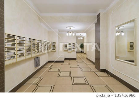 modern apartment lobby with mailboxes and polished tiles 135416960