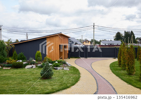 Sleek garage design with landscaped yard and privacy fencing Sleek garage design with landscaped yard and privacy fencing 135416962