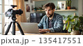 Young man recording online video lesson at home workspace 135417551