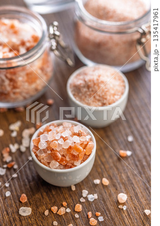 Pink Himalayan salt in bowl on wooden table. Pink Himalayan salt in bowl on wooden table. 135417961