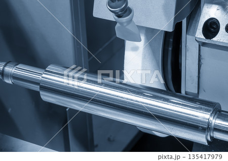 Close Up of Cylindrical Grinding Machine Working on Metal Shaft Parts 135417979