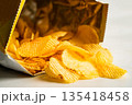 Potato chips, delicious BBQ seasoning spicy for crips, thin slice deep fried snack fast food in open bag. 135418458