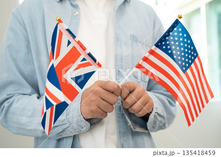 Learn English language, Asian teenage student hold book with flag in course at school. Learn English language, Asian teenage student hold book with flag in course at school. 135418459