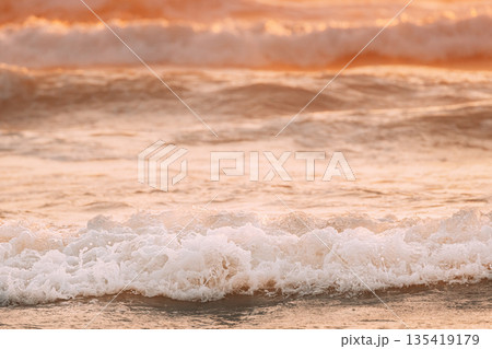 Evening sunlight sunshine above sea. Amazing landscape scenery. Sea ocean water warm colors. Sea ocean water surface with foaming small waves. Copy space. Nature background 135419179