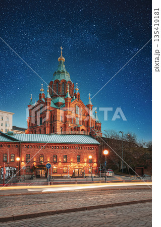 Helsinki, Finland. Uspenski Cathedral In Evening Illuminations Lights. Eastern Orthodox Cathedral Dedicated To Dormition Of The Theotokos - Virgin Mary. Night stars shining above street Helsinki, Finland. Uspenski Cathedral In Evening Illuminations Lights. Eastern Orthodox Cathedral Dedicated To Dormition Of The Theotokos - Virgin Mary. Night stars shining above street 135419181