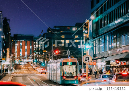 Helsinki, Finland. Tram Departs From A Stop On Kaivokatu Street In Helsinki. Night View Of Kaivokatu Street In Kluuvi District In Evening Or Night Illumination. Starry sky above scene. Night stars 135419382