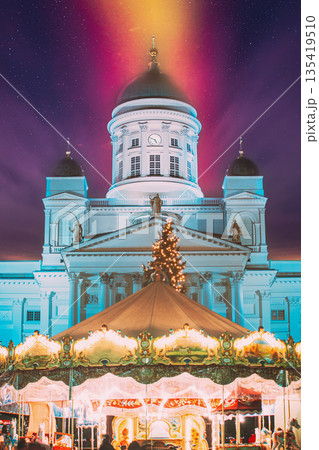 Helsinki, Finland. Xmas Market On Senate Square With Holiday Carousel And Famous Landmark Is Lutheran Cathedral In Winter Night 135419510