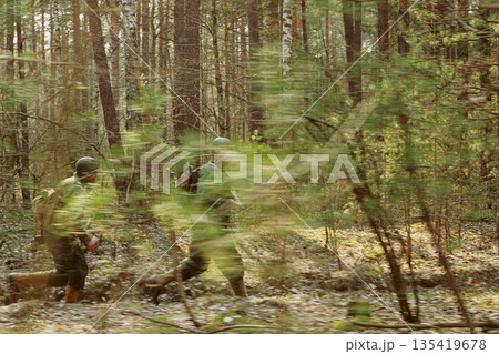 American Soldiers Of USA Infantry Of World War II Marching Running Run Along Forest In Autumn Spring Day. Group of soldiers 135419678
