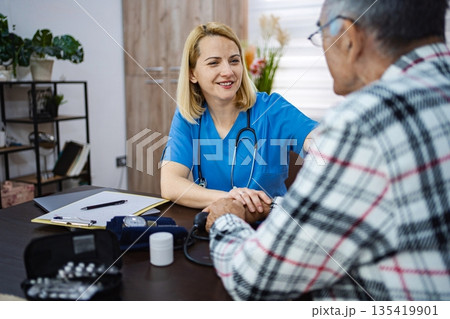 Compassionate caregiver aids senior patient in need 135419901