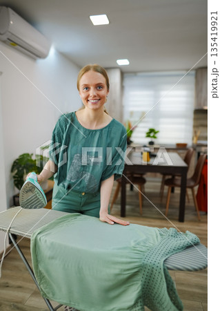 Bright moment of ironing clothes in a cozy home setting Bright moment of ironing clothes in a cozy home setting 135419921