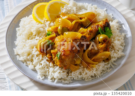 Braised Mustard Chicken Yassa with Rice on a plate Braised Mustard Chicken Yassa with Rice on a plate 135420010