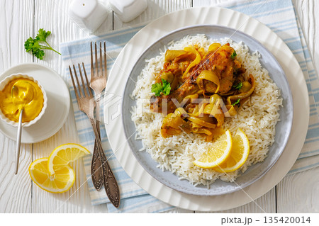 Braised Mustard Chicken Yassa with Rice on a plate 135420014