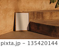 Minimal Empty Picture Frame Mockup Leaning Against Textured Beige Wall, Stairs in Warm Summer Sunlight. Mediterranean Exterior Background. Copy Space for Art, Photography, Branding. Poster Design 135420144